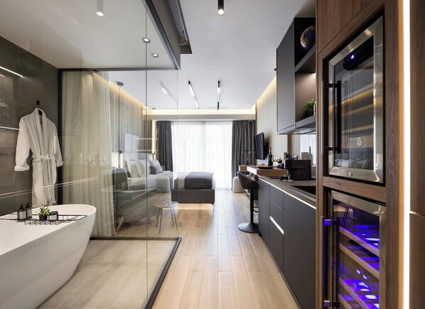 A modern bathroom with a large bathtub, a glass shower enclosure, and a vanity with a built-in sink.
