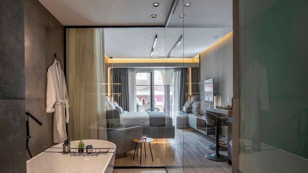 A modern bathroom with a large bathtub, a vanity with a mirror, and a shower area.
