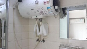 A hairdryer mounted on a wall with a towel rack below it. - Fushun Yuanxiang Hotel (Fushun)