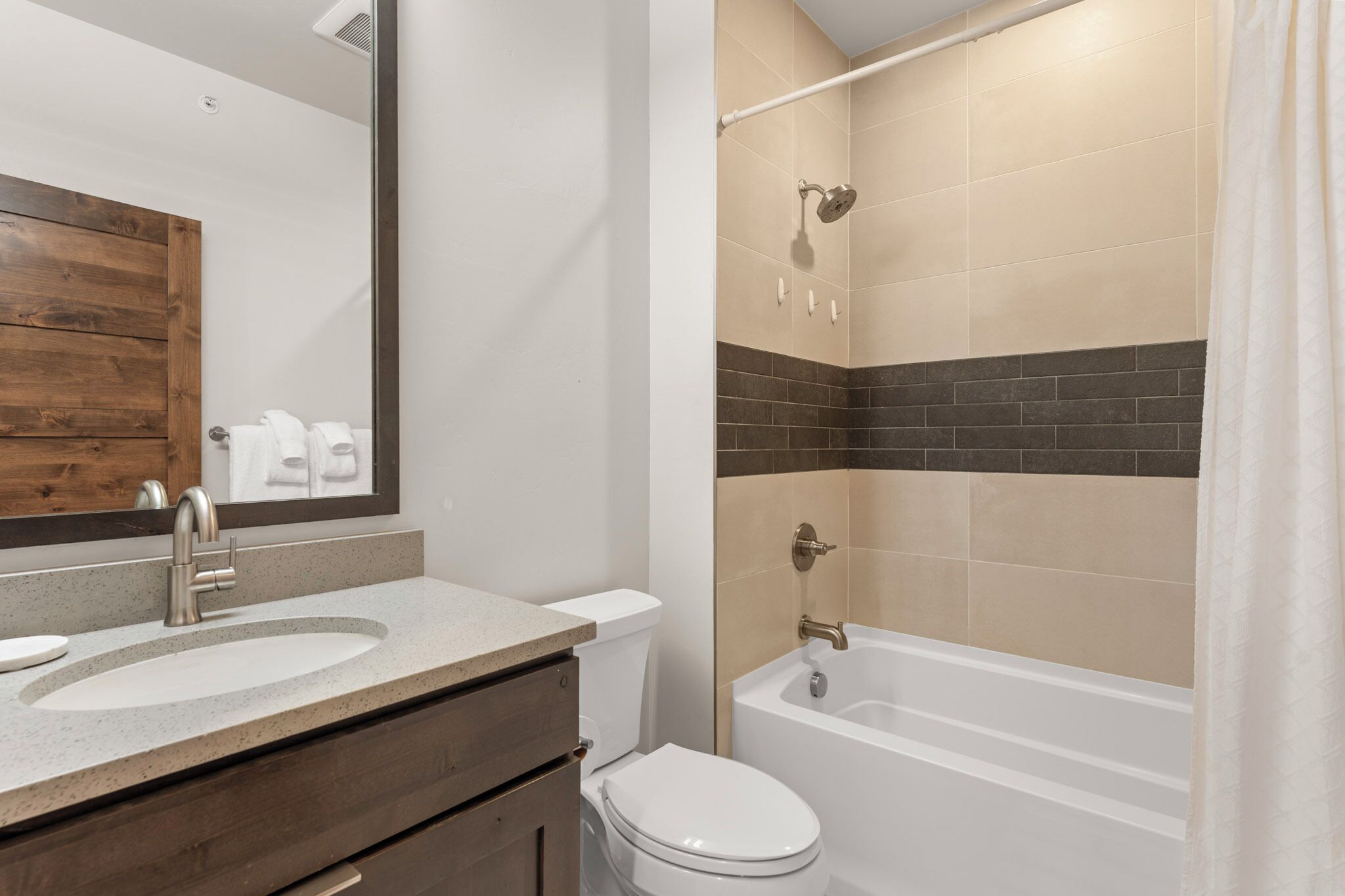 A bathroom with a sink, toilet, and bathtub.
