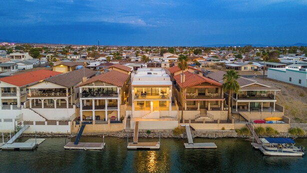 A coastal residential area with houses featuring balconies and waterfront access.