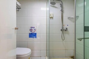 A bathroom with a toilet, a glass shower enclosure, and a wall-mounted towel rack. - 7Days Inn Chain Hotel (Kunming Dongjiawan Telecom Building) (Kunming)