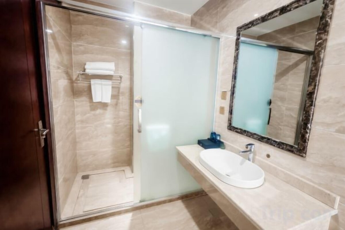 Shower, hair dryer, slippers, towels