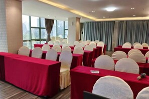 A conference room with rows of tables and chairs, large windows, and curtains. - Chaoman Hotel (Foshan Lingnan Tiandi Pearl Sports Stadium Branch) (Foshan)