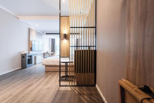 A modern hotel room with a wooden floor, a bed, a desk, and a large window. - HanTing Hotel (Dujiangyan) (Dujiangyan)