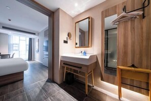 A modern bathroom with a wooden vanity, a large mirror, and a towel rack. - HanTing Hotel (Dujiangyan) (Dujiangyan)
