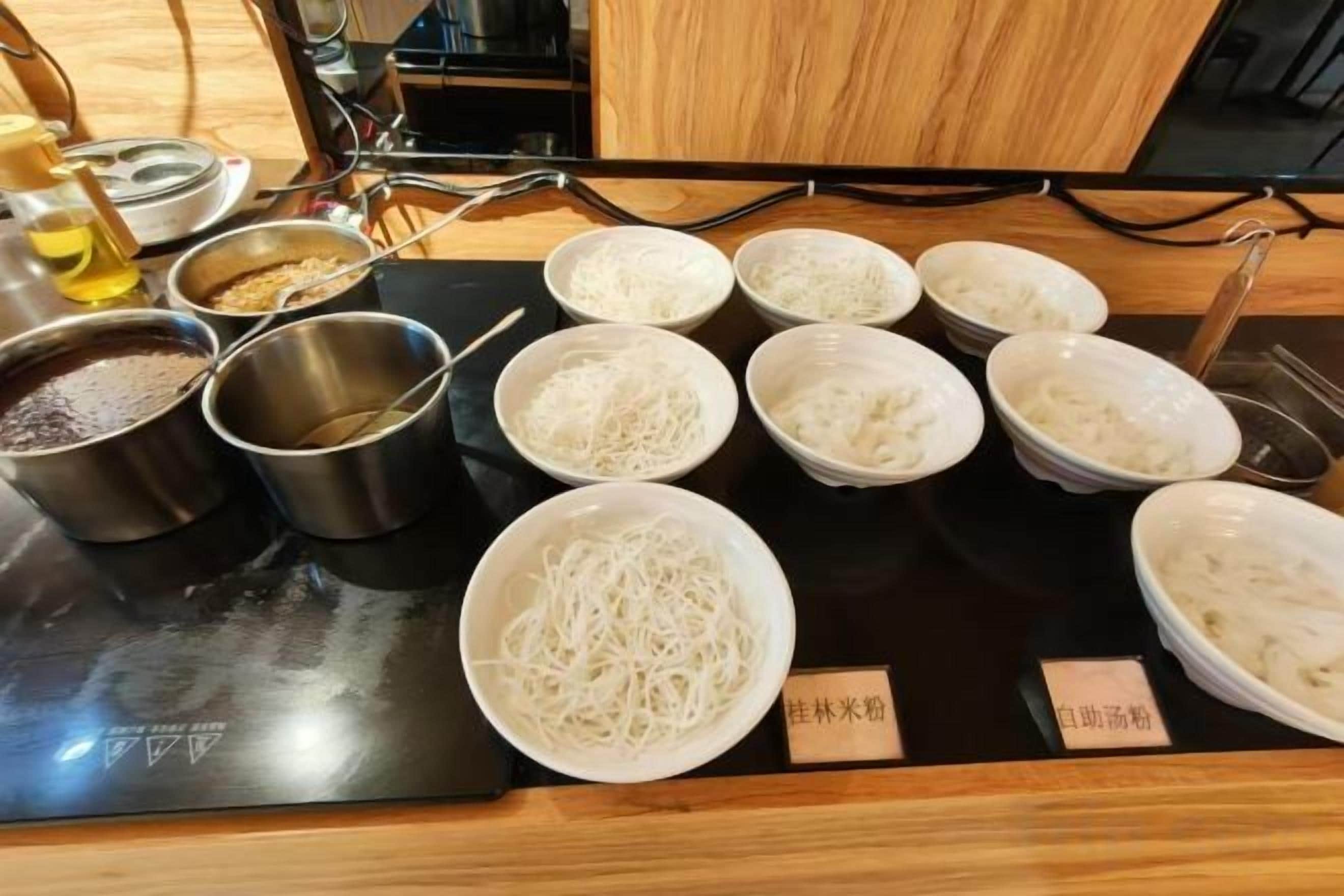 A kitchen counter with various cooking ingredients and utensils.