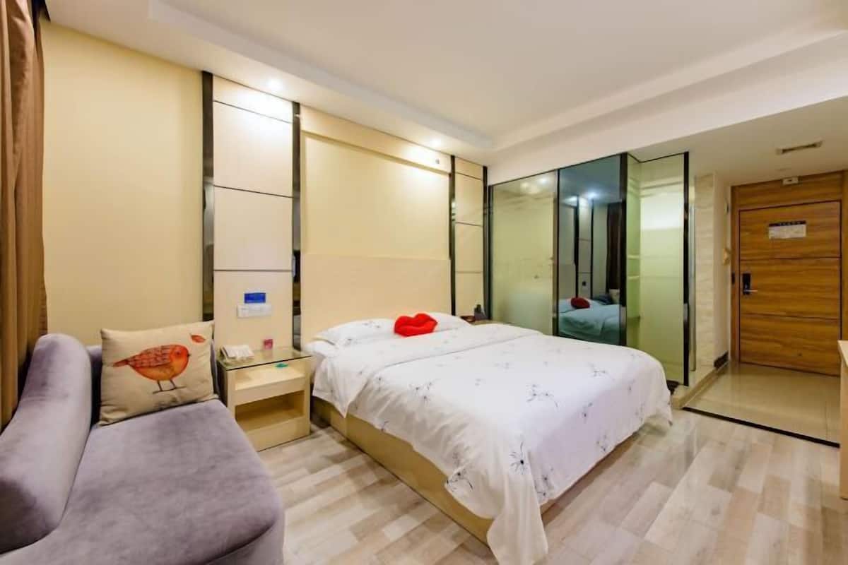 Un dormitorio moderno con cama, mesita de noche, silla y armario.