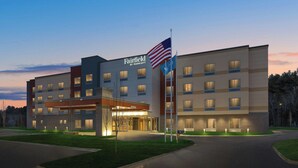 A Fairfield by Marriott hotel with a modern design, multiple floors, and a well-lit entrance. - Fairfield by Marriott Inn & Suites Traverse City (Traverse City)
