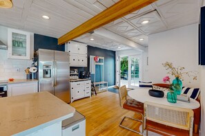 Enjoy cooking in this well-equipped kitchen with a spacious island and dining area.