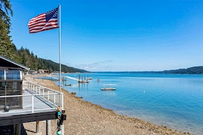 Enjoy a serene lakeside view with access to the shoreline via a walkway.