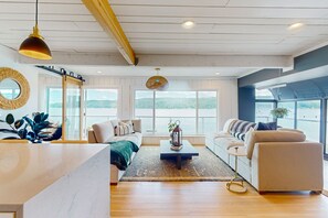 Relax in a spacious living area with a comfortable sofa and smaller couch, perfect for unwinding or socializing.