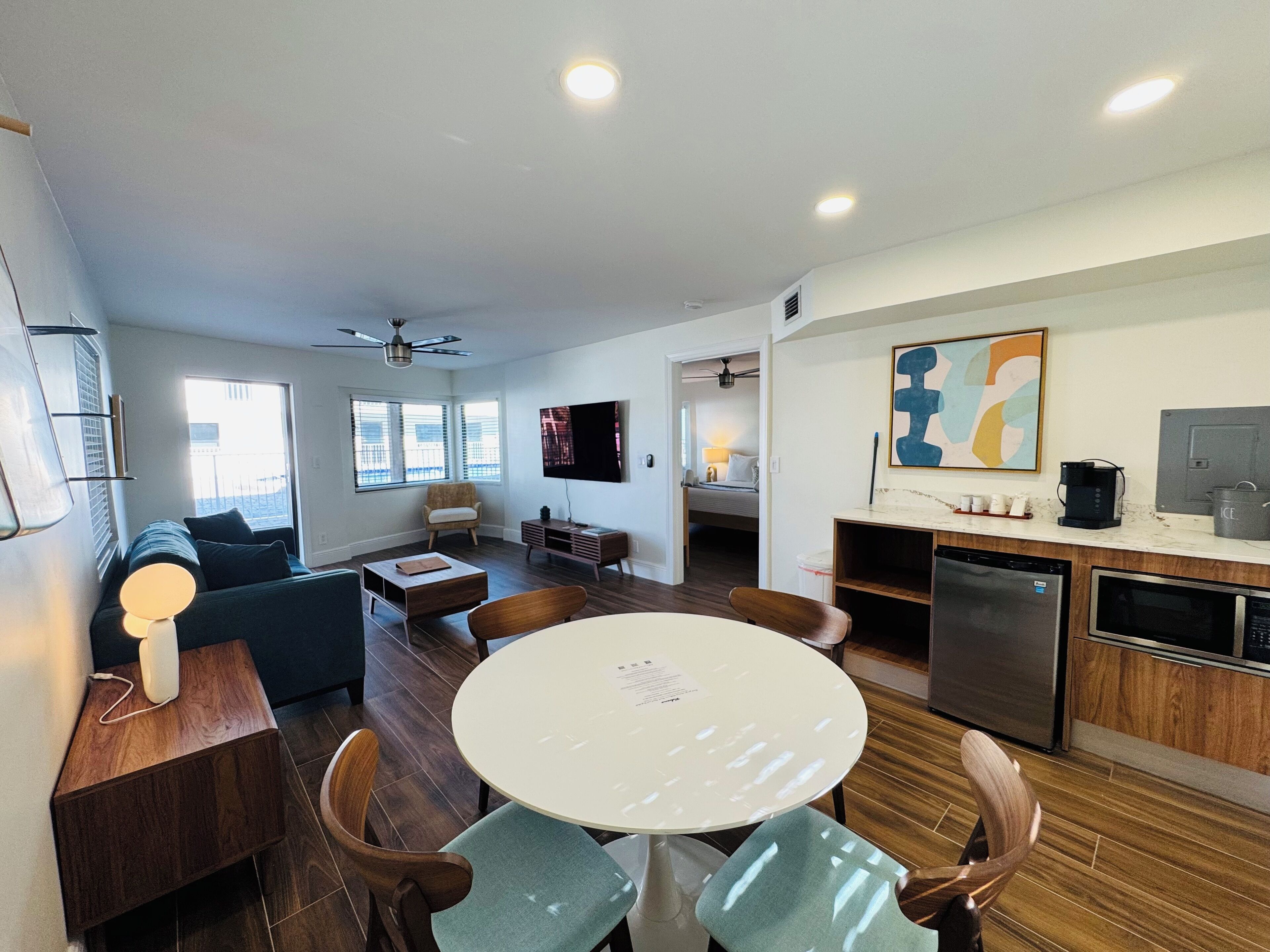 A modern apartment with a dining area, kitchen, and living room.