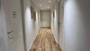 A hallway with wooden flooring, white walls, and doors labeled "Toilets". - PiazzaBolognaStay - beautiful home in Rome (Roma)