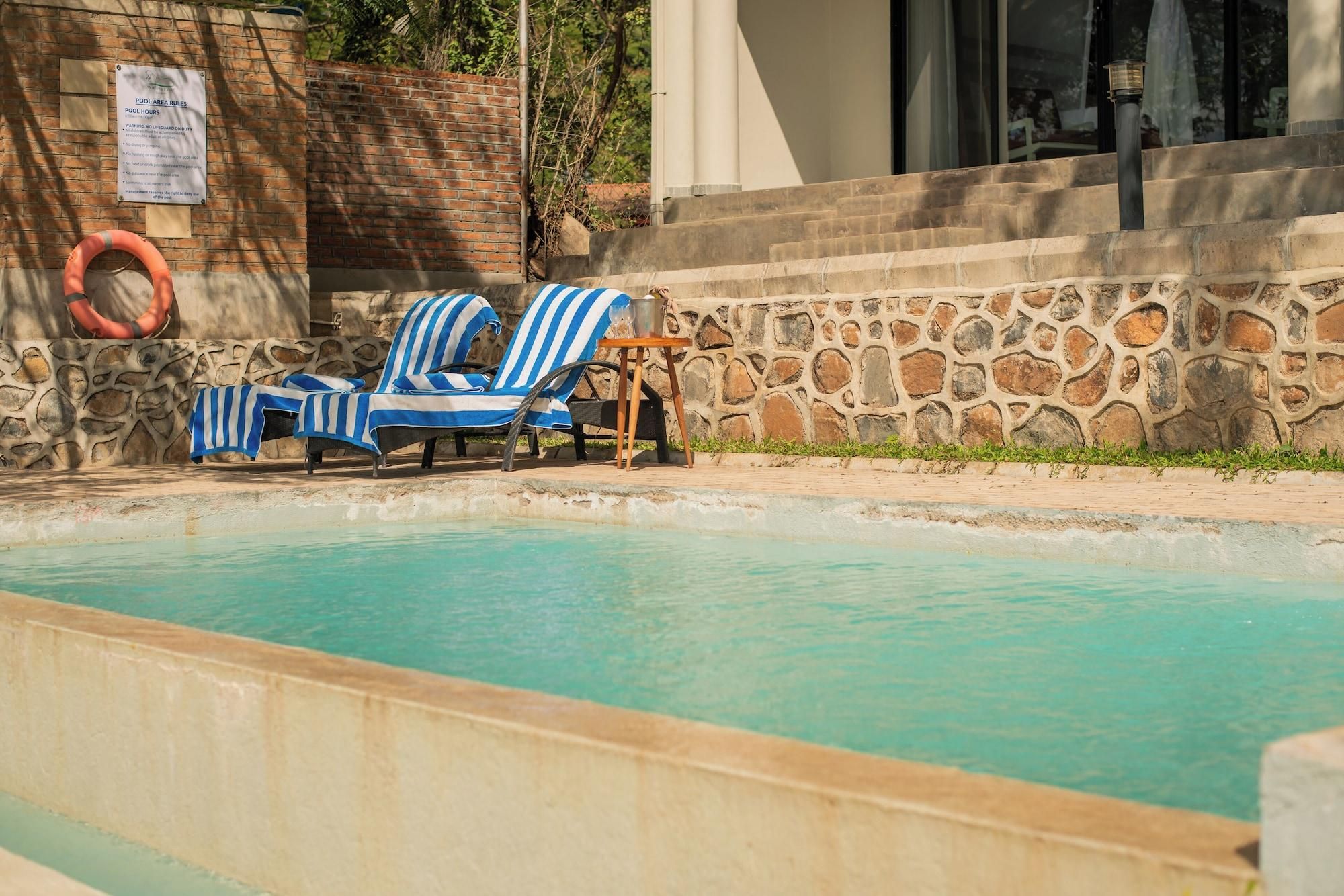 A pool area with lounge chairs and a lifebuoy.