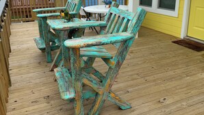 A wooden deck with turquoise-painted outdoor furniture, including chairs and a table. - Brand new beach home 3BR near beach and fishing (Surfside Beach)