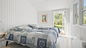A bedroom with two beds, a window, and a door leading outside. - 5 bedroom awesome home in Slagelse (Slagelse)