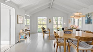 A spacious dining area with a high ceiling, large windows, and a view of the outdoors. - 5 bedroom awesome home in Slagelse (Slagelse)