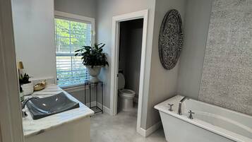 A bathroom with a sink, toilet, and bathtub.
