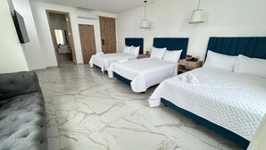 A hotel room with three beds, a grey sofa, and a marble floor. - Hotel Presidente Premium Salinas (Salinas)