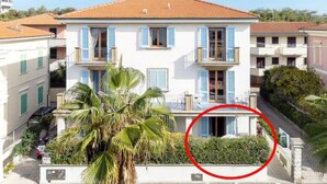 A two-story building with a red-tiled roof, white walls, and blue shutters. - Zì Maria (Cecina)