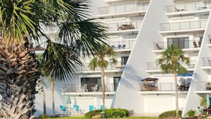 A multi-story hotel with balconies, outdoor seating, and palm trees. - Lovely and affordable oceanfront retreat, just steps from St. Augustine Beach (St. Augustine)