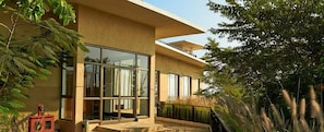 A modern building with large windows, a flat roof, and a balcony. - Club Mahindra Resort - Tungi (Ootacamund)