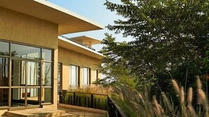 A modern building with large windows, a flat roof, and a balcony. - Club Mahindra Resort - Tungi (Ootacamund)