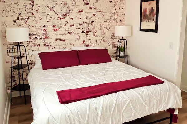 Bedroom with King bed, TV and desk - designated working space.