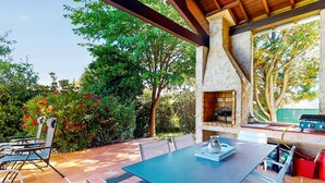 An outdoor patio with a table and chairs, a grill, and a water feature. - Beautiful home in Meyzieu (Meyzieu)