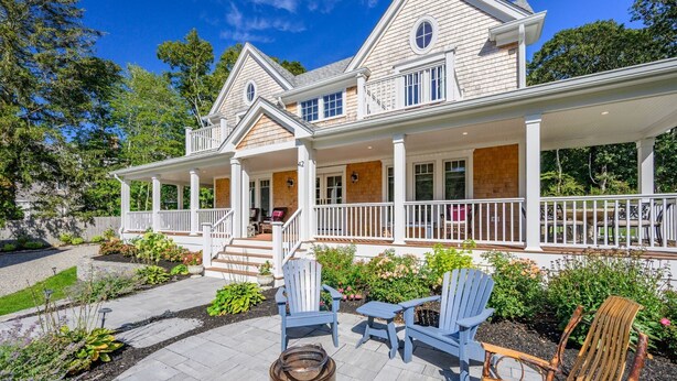 A two-story house with a covered porch, outdoor seating area, and a fire pit. - Coastal Escape: Steps to Red River Beach (Harwich Port)