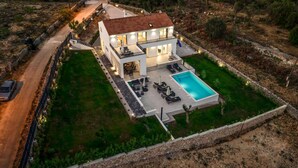 A modern two-story house with a swimming pool, outdoor seating, and a well-maintained lawn. - Pet friendly home in Sibenik (Sibenik)