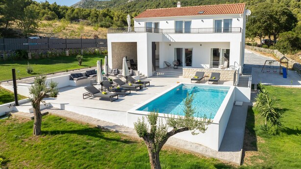 A modern two-story house with a swimming pool, outdoor seating, and a view of the surrounding landscape. - Pet friendly home in Sibenik (Sibenik)