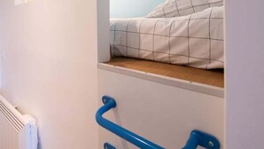 A bedroom with a bunk bed, a white radiator, and blue wall-mounted handles. - Valencio - Superb cosy apartment (Lyon)