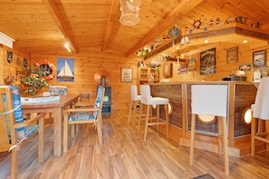 A wooden interior with a bar area, wooden furniture, and various wall decorations. - Apartment 'Offenbüttel' with Private Terrace, Shared Garden and Wi-Fi (Offenbüttel)