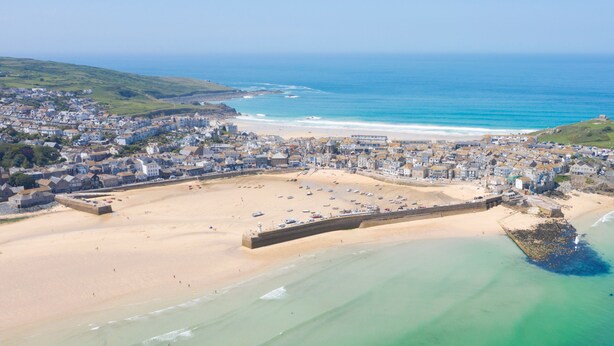 An aerial view of a coastal town with a sandy beach, a fortified structure, and a clear view of the ocean. - Quaint and cosy, this reverse layout barn conversion exudes original charm and ultimate luxury. Quin (Camborne)
