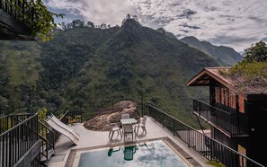 A pool area with a view of a mountainous landscape, surrounded by a wooden structure with a balcony. - Ella Deck Resort (Ella)