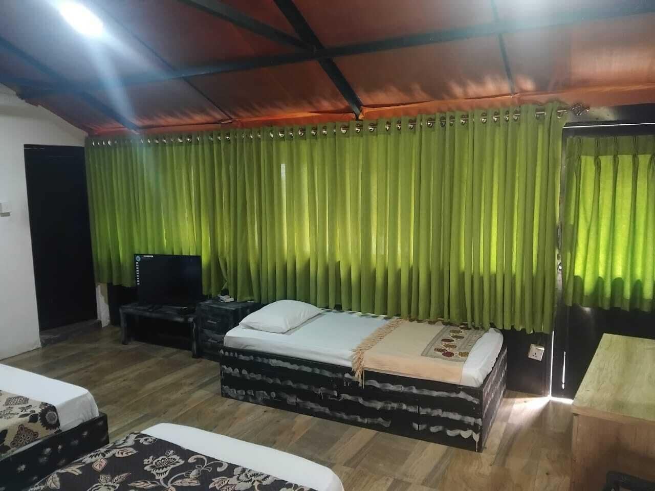 A room with a bed, a TV, and a desk.