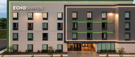 A modern hotel building with the name 'Echosuites' prominently displayed. It features a clean, rectangular design with multiple windows on each floor. The entrance is marked by a sign that reads 'Extended Stay by Wyndham'.