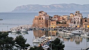 A coastal town with historic buildings, a marina with boats, and a mountainous backdrop. - Golden house vacation home with jacuzzi (Castellammare del Golfo)