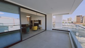 A modern apartment with a balcony, a living area with a sofa and armchairs, and a kitchen area. - 132 LCA - Stay Diamond Apartment (Larnaca)