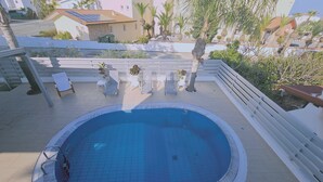 A rooftop swimming pool with a tiled deck, surrounded by white railings and potted plants. - 124 PRO - Stay Princess Villa (Paralimni)