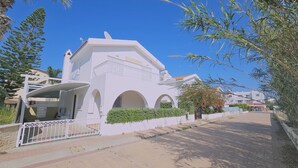 A white building with a flat roof, arched windows, and a gated entrance. - 124 PRO - Stay Princess Villa (Paralimni)