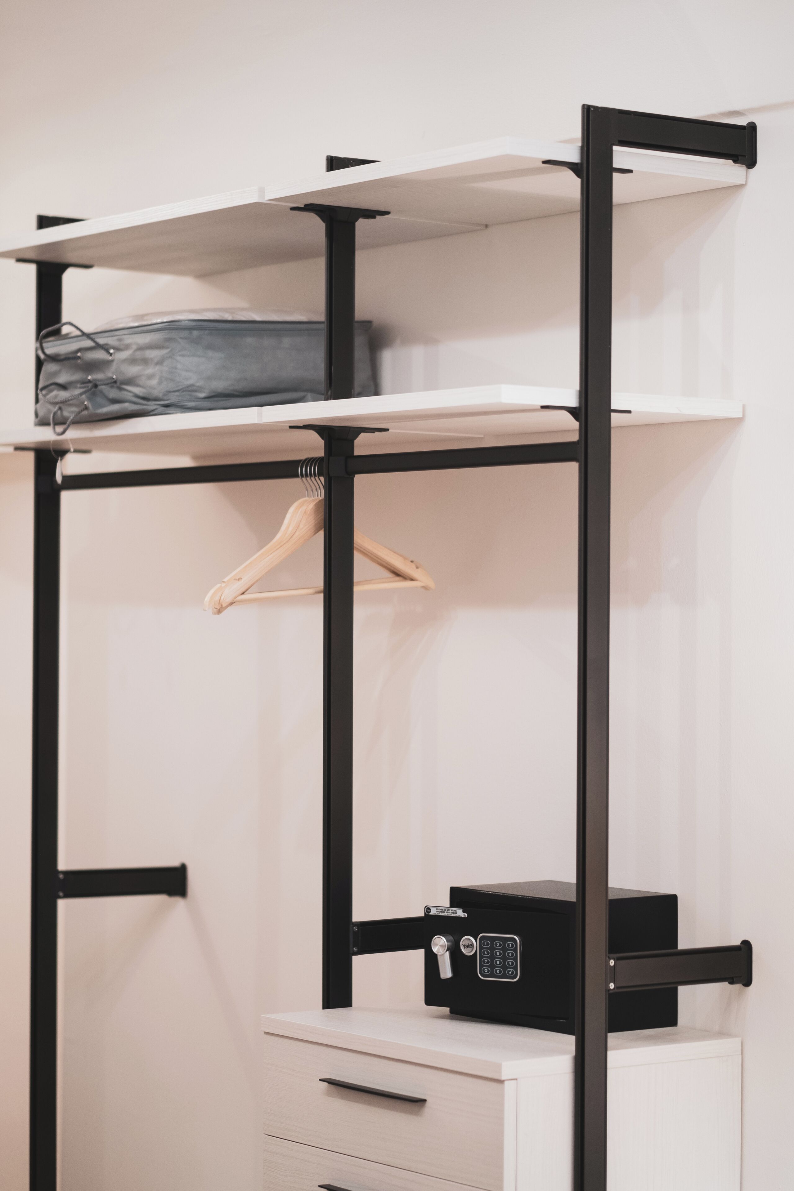 A bunk bed with a desk and a small cabinet.