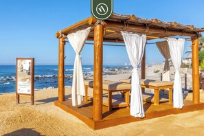 Relax in this beachside gazebo with ocean views and a spot to unwind.