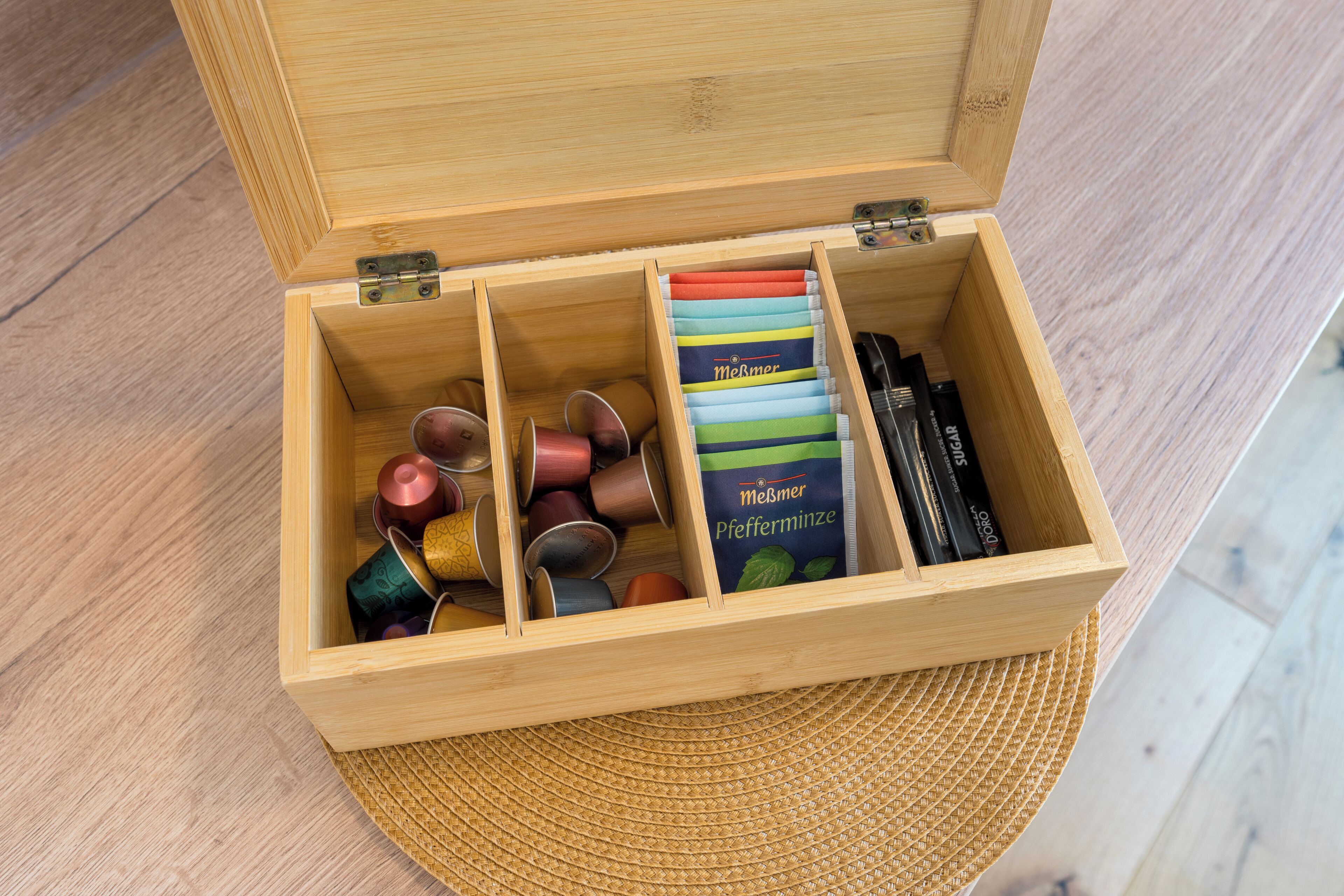 A wooden box with compartments containing various items.
