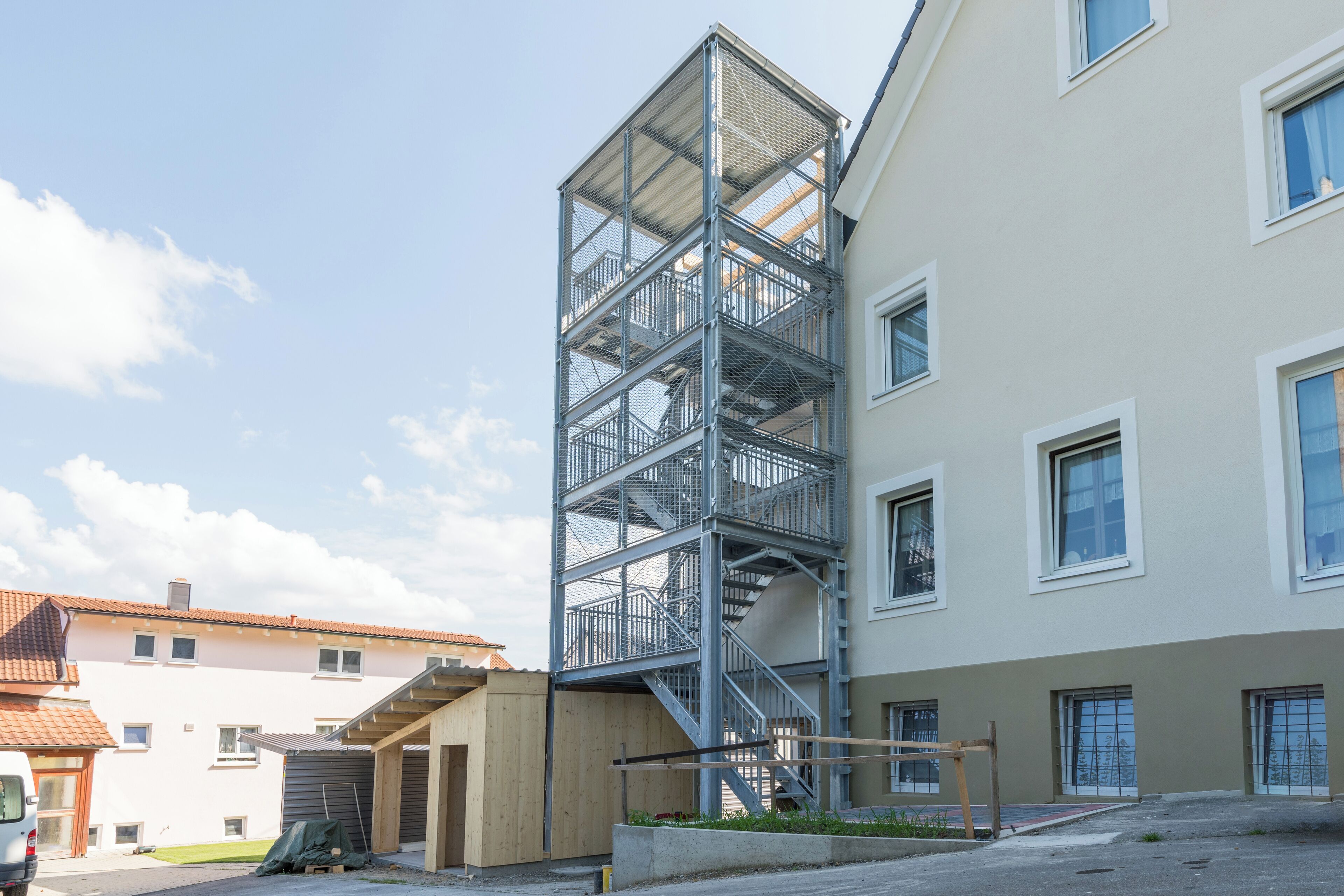 A multi-story building with a metal staircase leading to the upper floors.