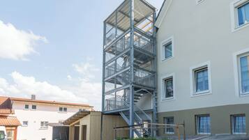 A multi-story building with a metal staircase leading to the upper floors.
