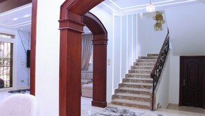 Un escalier avec des rampes en bois et une plateforme recouverte de moquette.