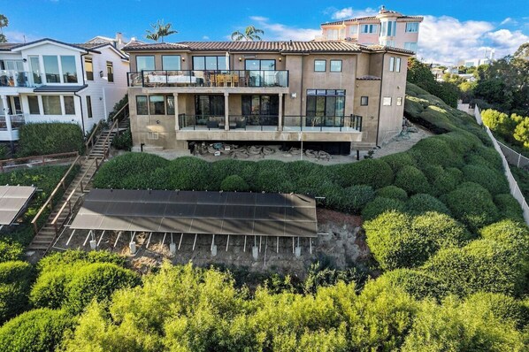 A modern house with a large balcony, solar panels, and well-maintained landscaping. - Panoramic Ocean Views, Custom Bluffside Estate, Dana Point (Dana Point)